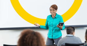 smiling woman standing in front of class