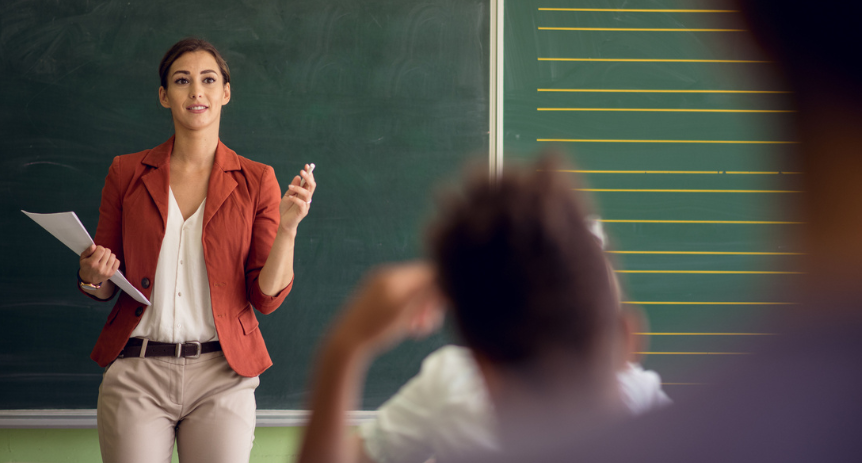 woman standing in front of a classroom teaching