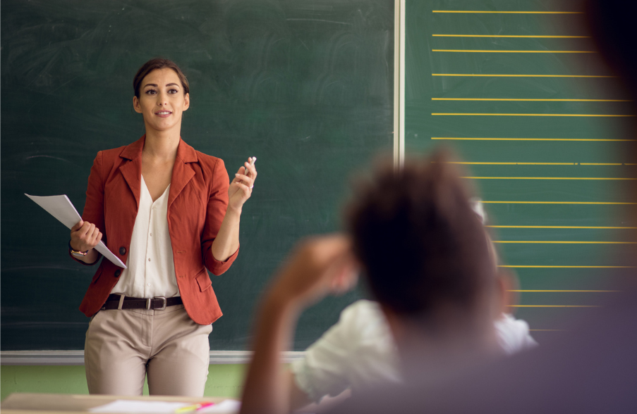 woman standing in front of a classroom teaching
