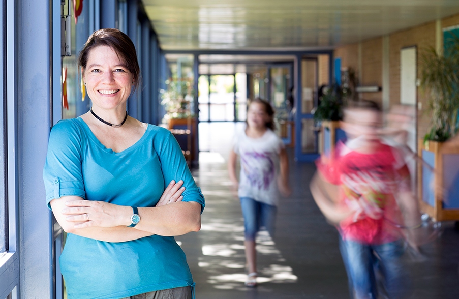 Teacher smiling in hallway