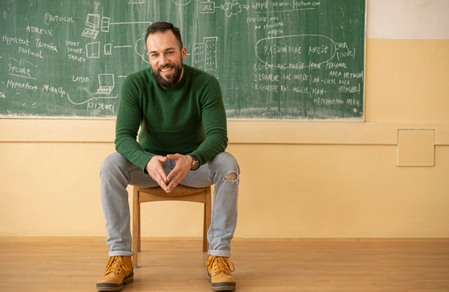 man sitting in front of a chalk board