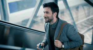 business man walking up elevator happily