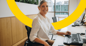 woman smiling while sitting at desk