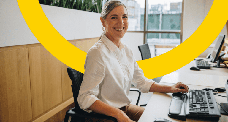 woman smiling while sitting at desk