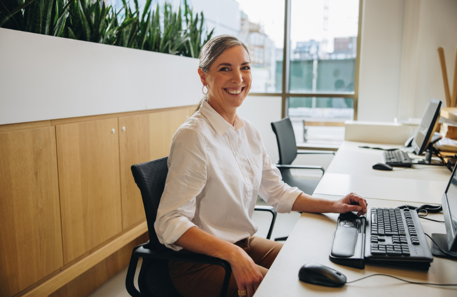 woman smiling while sitting at desk