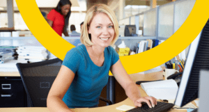 smiling blonde woman on computer