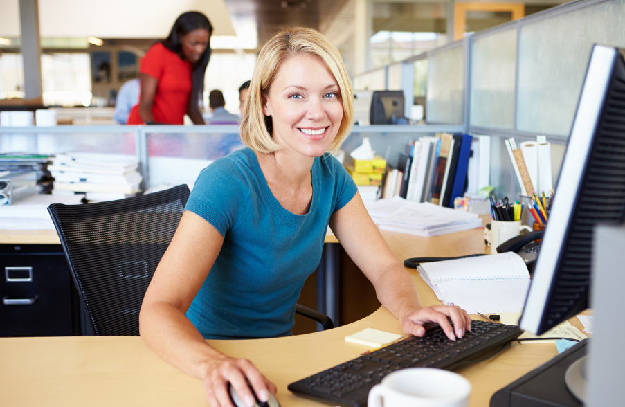 smiling blonde woman on computer