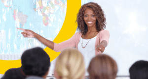 smiling woman standing in front of class of kids