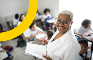 woman smiling in front of a classroom