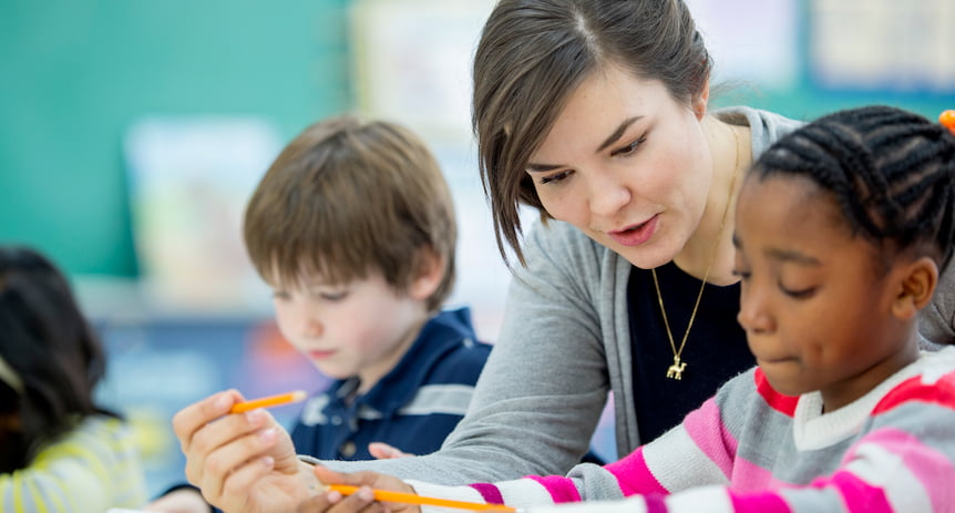 Substitute teacher working 1:1 with a student in the classroom